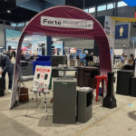 Maroon Forté Products canopy over waste and recycling bins at a convention center trade show booth